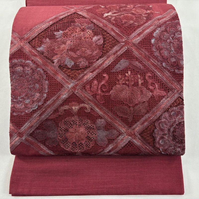美品】 袋帯 秀品 紬地 花丸文 華文 刺繍 赤紫 お太鼓柄 正絹｜中古