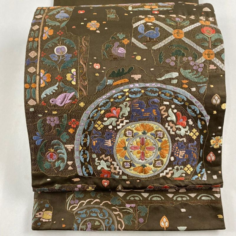 袋帯 逸品 華文 動物 刺繍 金糸 茶緑色 お太鼓柄 正絹｜中古